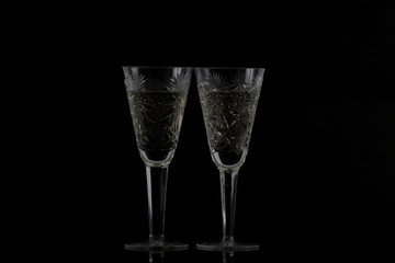 two glasses of champagne on a black background