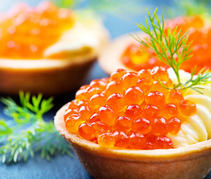 Tartlet with red caviar close up. Gourmet food, appetizer