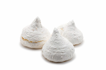 Three white french meringues, isolated on white background