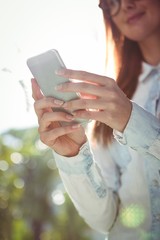 Smiling woman using smartphone