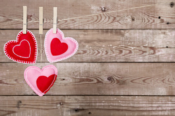 Clothesline with Valentine's Day hearts decorations on a rustic