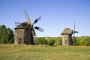 Fototapeta na wymiar Windmills standing in the field against the blue sky