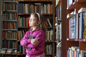 beautiful little girl in library