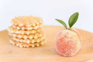 Candy fruits on wooden plate isolated on white