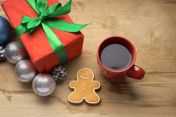 Christmas gift with a cup of coffee on the table