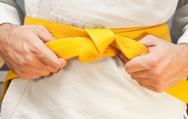 Aikido yellow belt on white kimono