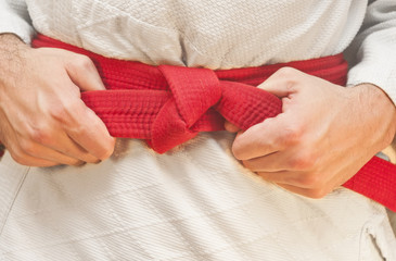 Aikido red belt on white kimono