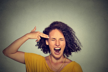 Stressed woman committing suicide with finger gun gesture