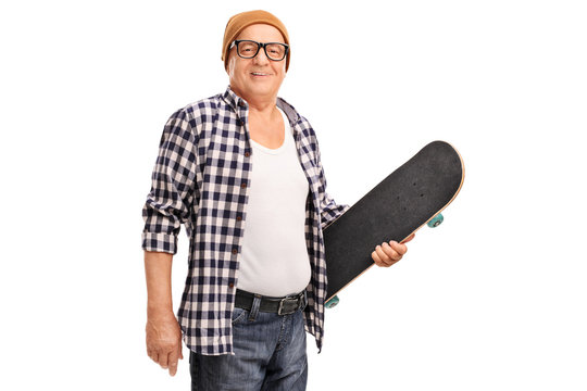 Senior hipster holding a skateboard