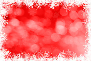 red bokeh background and white snowflakes frame with copyspace.