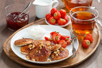 Breakfast. Pancakes with fresh strawberries and cream, jam 