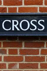 Obraz premium Vintage Grunge Brick Wall Cross Word Sign