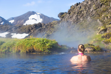 Young woman relax hot spring in Iceland Landmannalaugar
