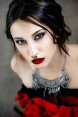 Fototapeta premium Beautiful woman with cute face bright make up red lips and piercing on nose