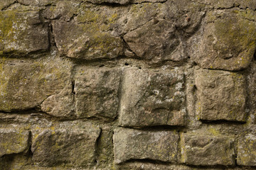 Cloce-up of old stone wall covered with moss