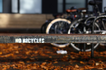 No Bicycles Painted Sign on Old Rusty Metal Fence in Oxford, UK.