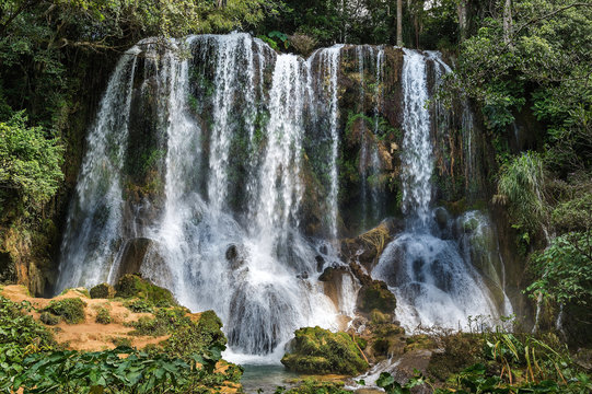 Waterfall in a lush rainforest. Beautiful waterfalls or cascades in El Nicho, El Nicho waterfall, in Scambray mountains. Cienfuegos province, Cuba.