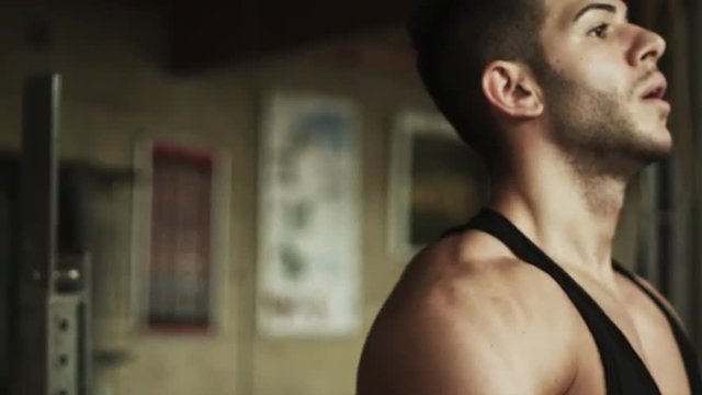 Transition shot of sporty young man flexing muscles and lifting dumbbells in gym