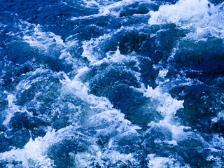Fototapeta na wymiar blue clear water bubbling and flowing