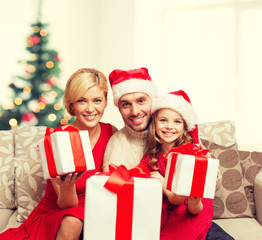 smiling family giving many gift boxes