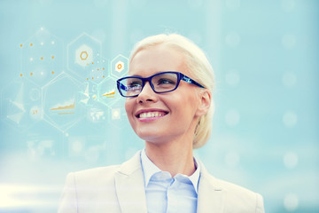 young smiling businesswoman in eyeglasses outdoors