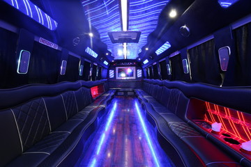 a big party bus fill ed with comfortable seats and shiny bright floor for dancing and having fun - Powered by Adobe