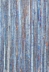 Grasscloth wallpaper sample in blue and brown tones