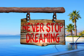 Never stop dreaming motivational phrase sign