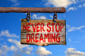 Never stop dreaming motivational phrase sign