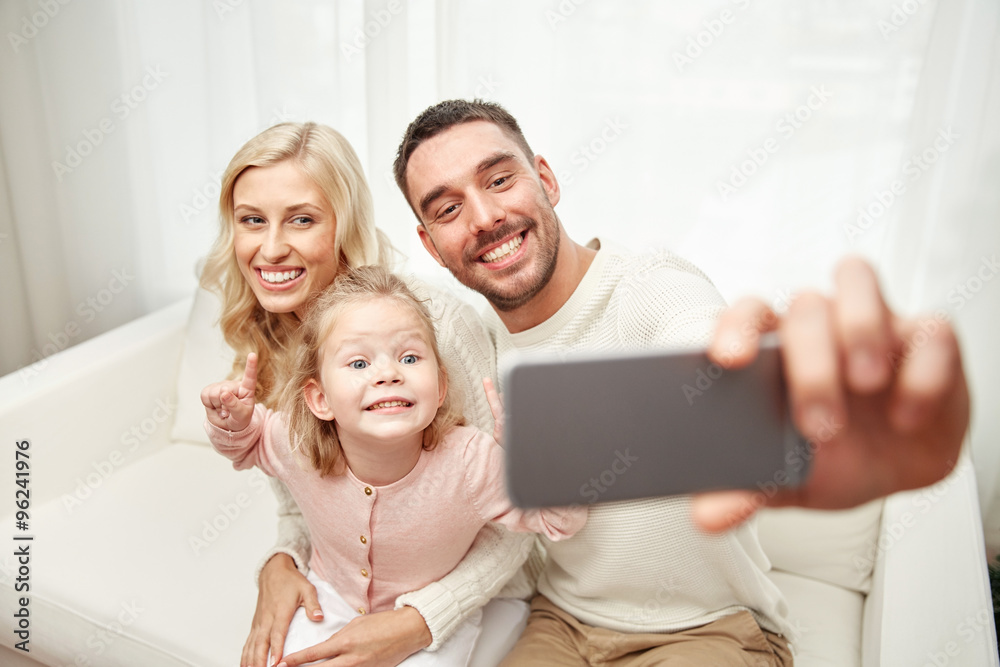 Poster family taking selfie with smartphone at home