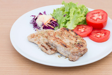 Grilled beef steak with salad  on wooden board