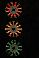 Copper windings of old motor stators against black background