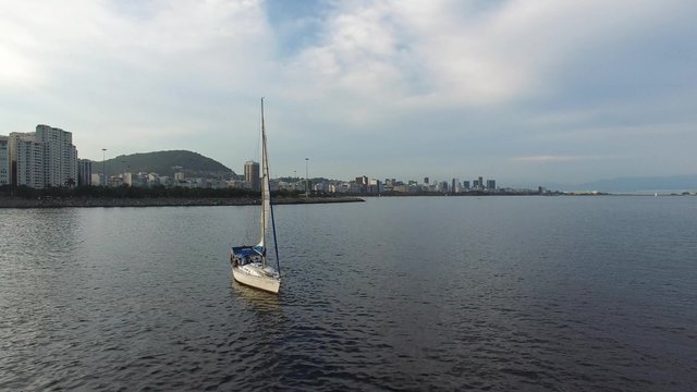 Sailboat Travel on Guanabara Bay with Sugarloaf Mountain background in Rio de Janeiro, Brazil.