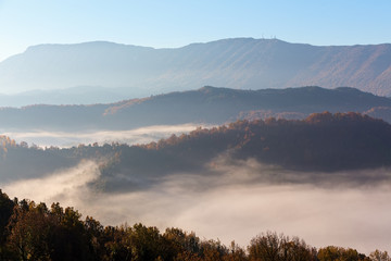 Fototapeta na wymiar autumn scenery up early with fog in Zagorochoria, Epirus Greece