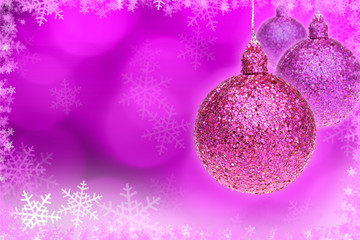 pink Christmas ball and pink bokeh background with copy space.