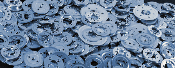 Various blue aluminum spacers and washers, industrial background