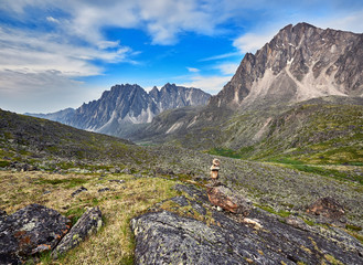Fototapeta na wymiar Pyramid of stones - a pointer to the path in the mountain tundra