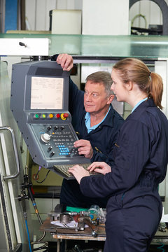 Engineer And Apprentice Using Computerized Cutting Machine