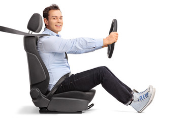 Young man driving seated on car seat