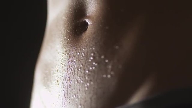 Portrait of active fitness woman's waist sweating from workout