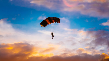 Skydiver On Colorful Parachute In Sunny Sunset Sunrise Sky