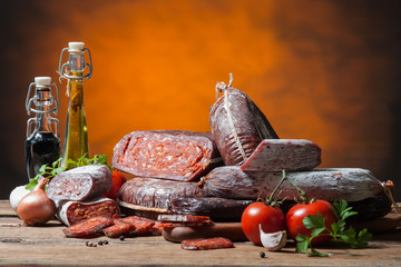 Variety of sausage products with vegetables