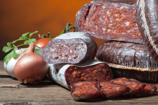 Variety of sausage products with vegetables