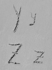 Sand font or letter set or collection on an exotic beach near the sea in summer