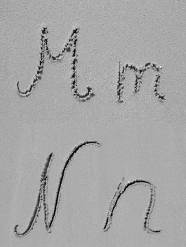 Sand font or letter set or collection on an exotic beach near the sea in summer