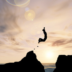 Human man silhouette jumping at sunset