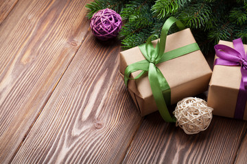 Fototapeta na wymiar Christmas gift boxes and fir tree on table