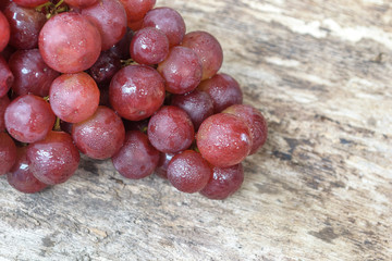 Bunch of grapes on wooden background.