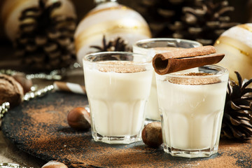 Eggnog with milk, cinnamon, grated nutmeg, decorated with fir co