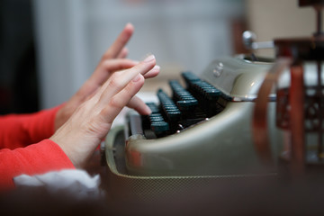 Hands of a man typing on typewriter
